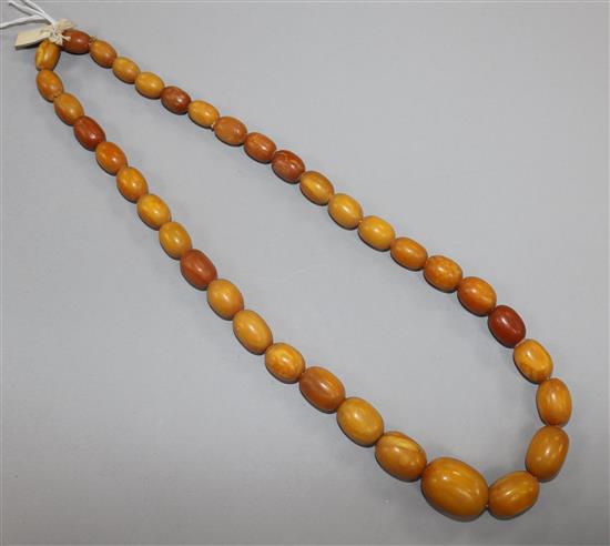 A single strand graduated oval amber bead necklace, gross weight 61 grams, 58cm.